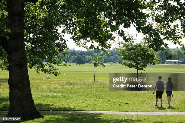 young lovers walking in regents park - regents park stock pictures, royalty-free photos & images