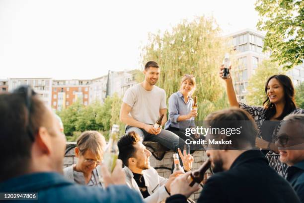 male and female friends enjoying at social gathering - bar berlin stock pictures, royalty-free photos & images