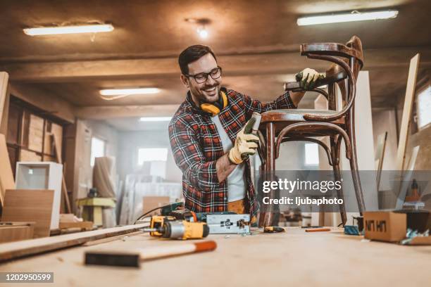 male furniture designer carefully sanding a chair frame - restoring art stock pictures, royalty-free photos & images