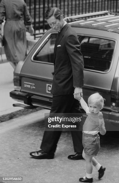 Charles, Prince of Wales holding the hand of his son Prince William on their at the Lindo Wing of St Mary's Hospital to visit and Diana, Princess of...