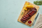 Barbecue pork ribs. Slow cooking recipe. Whole pickled roasted pork meat with red sauce