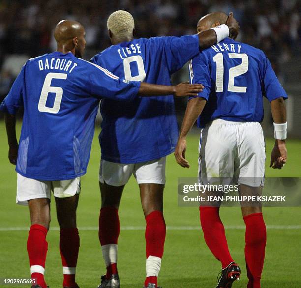 French midfielder Olivier Dacour, French forward Djibril Cisse, French forward Thierry Henry jubilate after the first goal during their soccer...