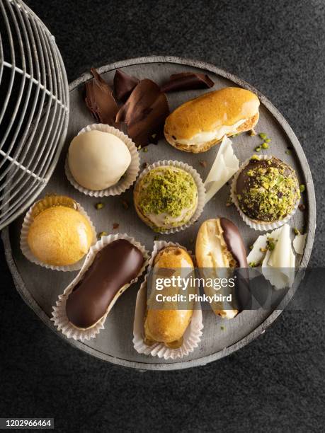 eclair,french eclairs,cream puff,truffles, - choux pastry stock pictures, royalty-free photos & images