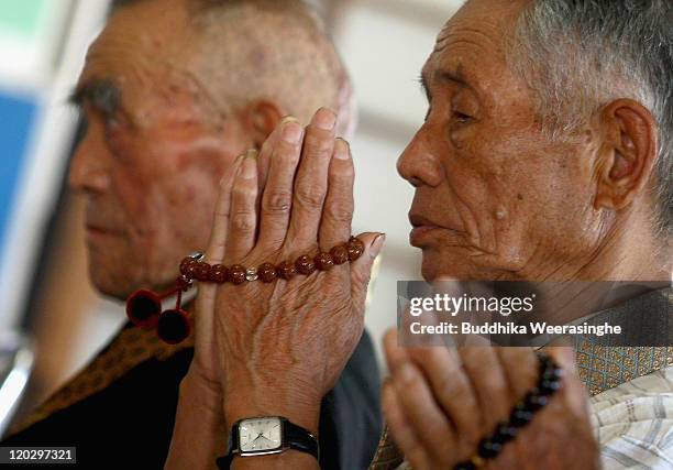 Survivors of the atomic bomb who evacuated from Hiroshima, mark the 66th anniversary of the world's first atomic bomb attack, at Buddhist Temple on...