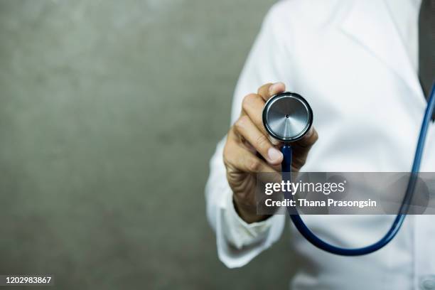 doctor using digital tablet - stethoskop stock-fotos und bilder