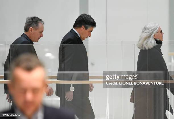 Former French prime minister Francois Fillon and his wife Penelope arrive at Paris courthouse for their trial on February 24, 2020. - Francois Fillon...