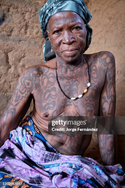 Portrait of a middle aged Dukkawa woman heavily tattooed over her body.