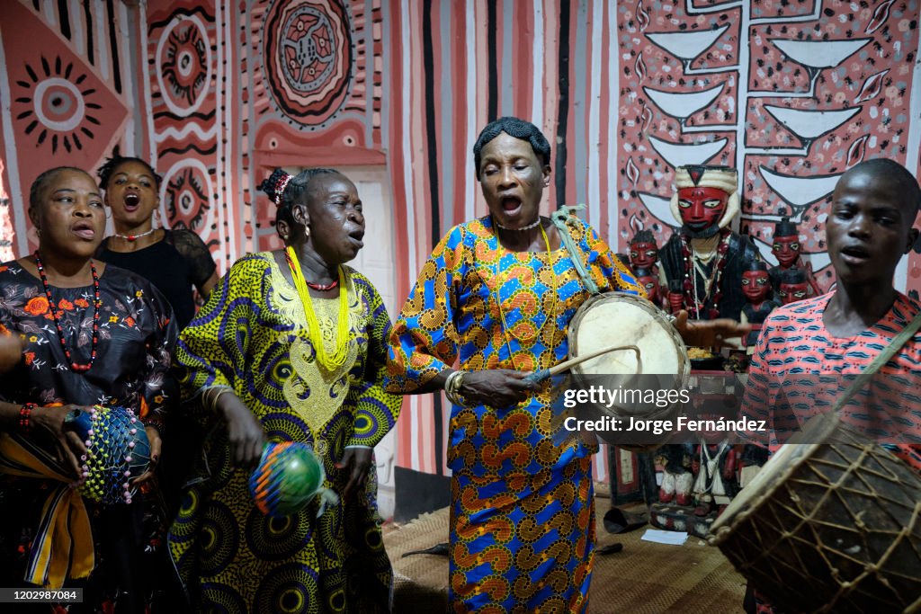 Priestess of the Osun temple playing music and dancing...