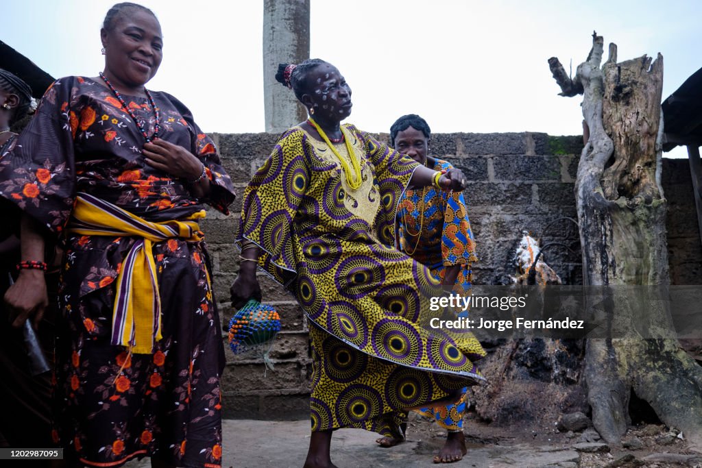 Priestess of the Osun temple playing music and dancing...