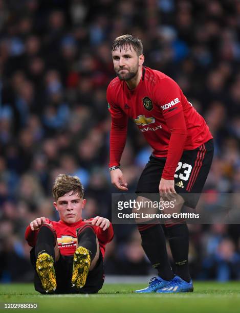 Brandon Williams and Luke Shaw of Manchester United look dejected during the Carabao Cup Semi Final match between Manchester City and Manchester...