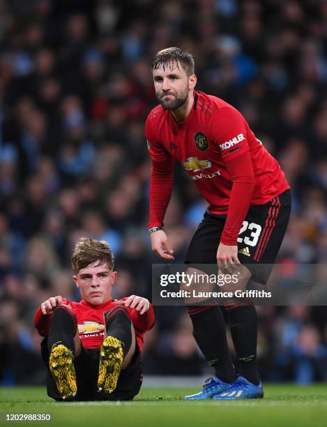 Brandon Williams and Luke Shaw of Manchester United look dejected during the Carabao Cup Semi Final match between Manchester City and Manchester...