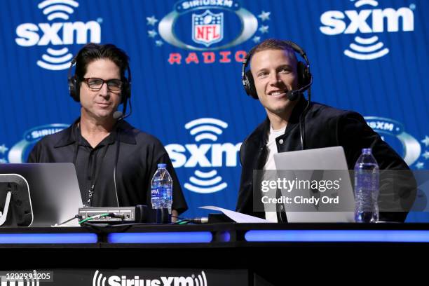 SiriusXM host Ed McCaffrey and NFL running back, Christian McCaffrey of the Carolina Panthers speak onstage during day 2 of SiriusXM at Super Bowl...