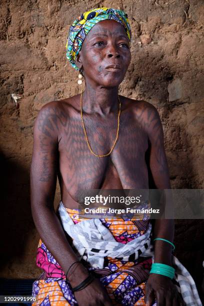 Portrait of a middle aged Dukkawa woman heavily tattooed over her body.