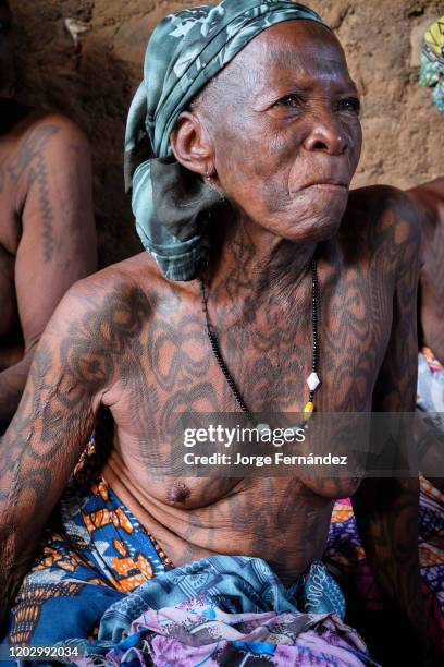 Portrait of a middle aged Dukkawa woman heavily tattooed over her body.