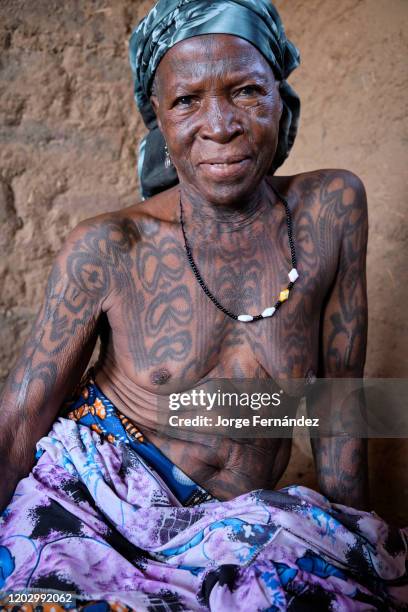 Portrait of a middle aged Dukkawa woman heavily tattooed over her body.