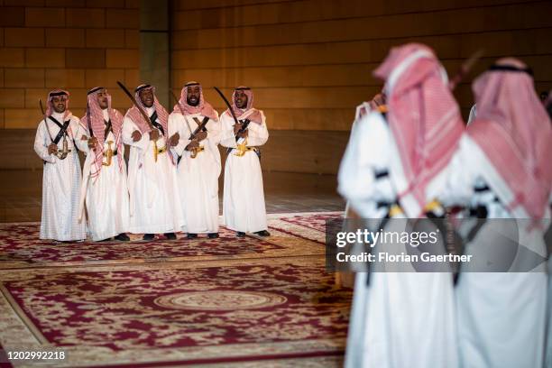 Men in traditional clothes are pictured in front of the Al Murabba Palace on February 22, 2020 in Riad, Saudi Arabia.