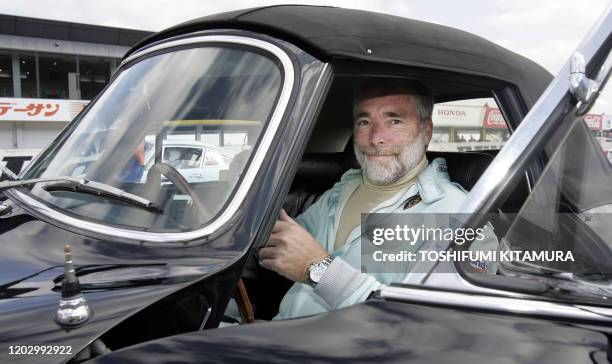 German legend driver Jurgen Barth sits in his Porsche 2000 GS Cabriolet on the starting grid prior to the class 2 race of the Le Mans Classic Japan...