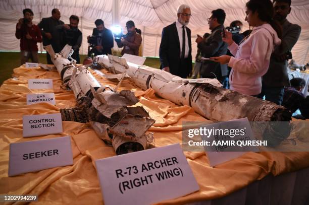 Media personnel take images of missiles of an Indian Mig-21 fighter aircraft, which was being flown by Indian pilot Wing Commander Abhinandan...