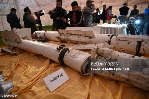 Media personnel take images of missiles of an Indian Mig-21 fighter aircraft, which was being flown by Indian pilot Wing Commander Abhinandan...