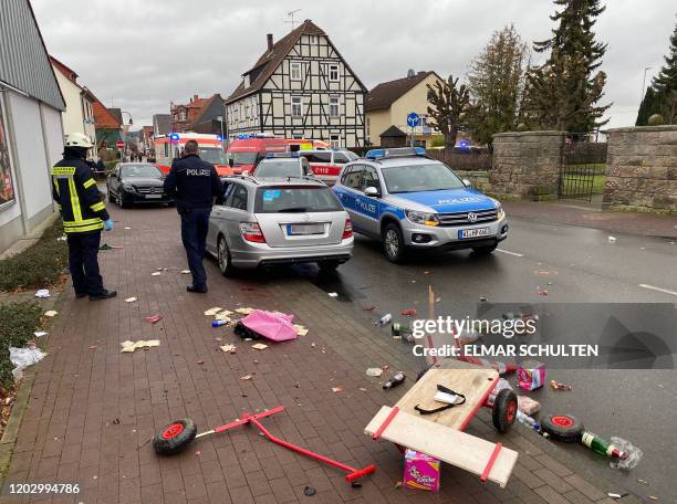 Broken handcart is seen in front of cars of the police, the fire brigades and an ambulance on Rose Monday, February 24, 2020 in Volkmarsen near...