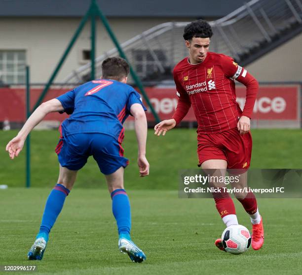 Curtis Jones of Liverpool and Ryan Leonard of Sunderland in action during the Premier League Cup game on February 24, 2020 in Kirkby, England.