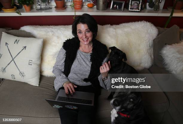 Author Tracy McArdle Brady, winner of the nationwide Erma Bombeck Contest in Humor Writing poses with her dogs Onny, on couch, and Ella in foreground...