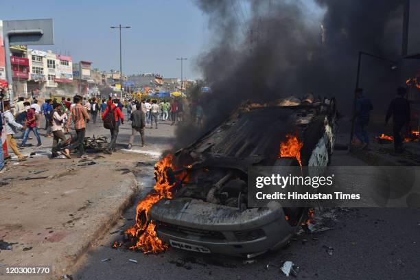 Car is burnt during violent clashes between anti and pro CAA demonstrations at Bhajanpura on February 24, 2020 in New Delhi, India. A Delhi Police...