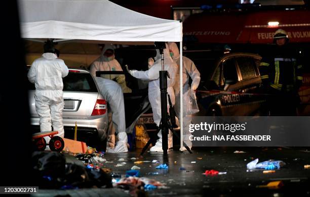 Police officers investigate the car of the man who drove into a carnival procession on February 24, 2020 in Volkmarsen near Kassel, central Germany....