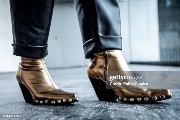 Covi Riva wears Au Revoir Cinderella shoes, Zara trousers, Hermes handbag and Alessandro dell'Acqua coat at IFEMA during Mercedes Benz Fashion Week...