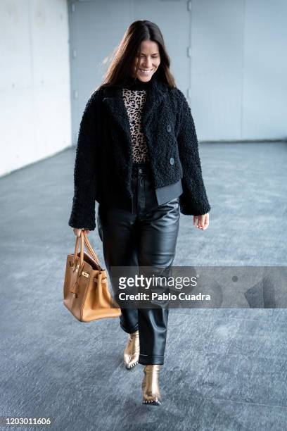 Covi Riva wears Au Revoir Cinderella shoes, Zara trousers, Hermes handbag and Alessandro dell'Acqua coat at IFEMA during Mercedes Benz Fashion Week...