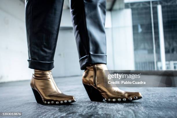 Covi Riva wears Au Revoir Cinderella shoes, Zara trousers, Hermes handbag and Alessandro dell'Acqua coat at IFEMA during Mercedes Benz Fashion Week...