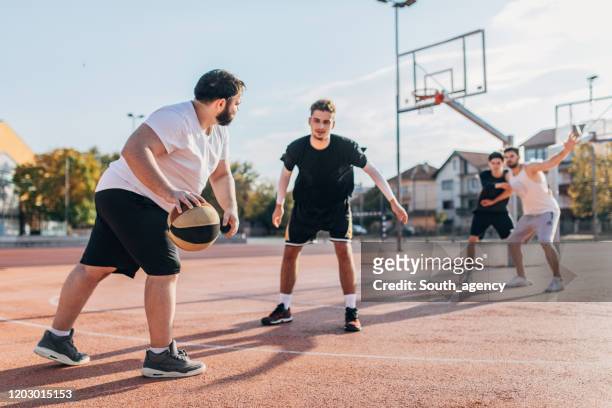 men friends playing basketball - blocking sports activity stock pictures, royalty-free photos & images