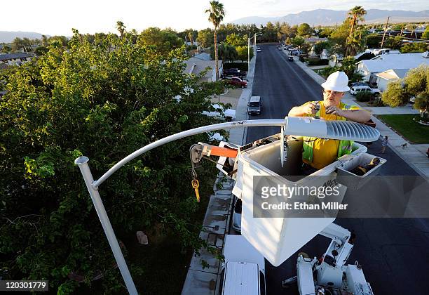 City of Las Vegas field electrician John Meier replaces a streetlight with a new LED fixture August 3, 2011 in Las Vegas, Nevada. The 6,600 new...