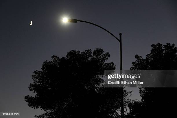 Waxing crescent moon is seen behind a streetlight with a newly-installed LED fixture August 3, 2011 in Las Vegas, Nevada. The city is replacing 6,600...