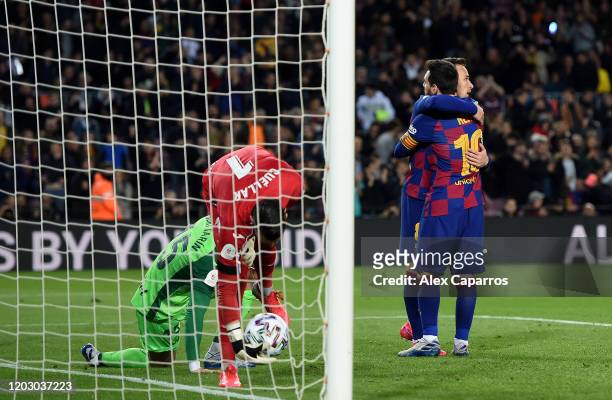 Arthur Melo of FC Barcelona is congratulated by team mate Lional Messi after scoring the fourth goal during the Copa del Rey Round of 16 match...