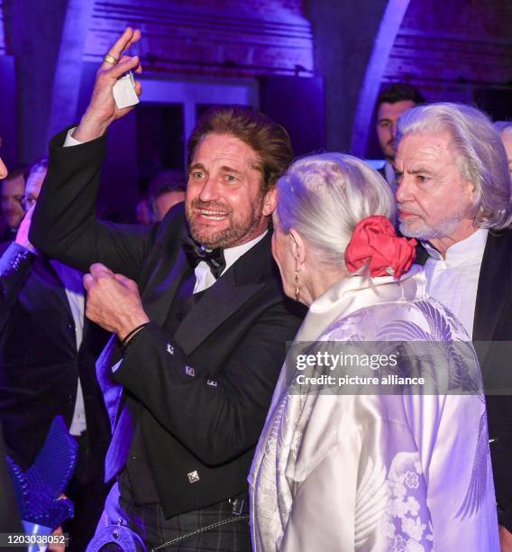 February 2020, Berlin: 70th Berlinale, Cinema for Peace Gala: actor Gerard Butler , director Vanessa Redgrave, and Hermann Bühlbecker. The...