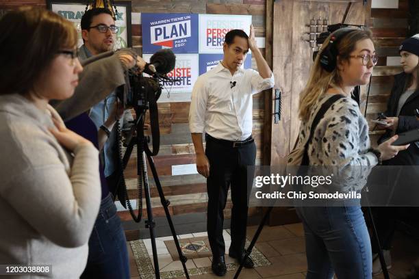 Former Housing and Urban Development Secretary Julian Castro waits for an interview while campaigning on behalf of Democratic presidential candidate...