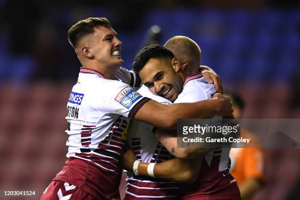 Bevan French celebrates with Oliver Partington of Wigan Warriors after their first try during the Betfred Super League match between Wigan Warriors...
