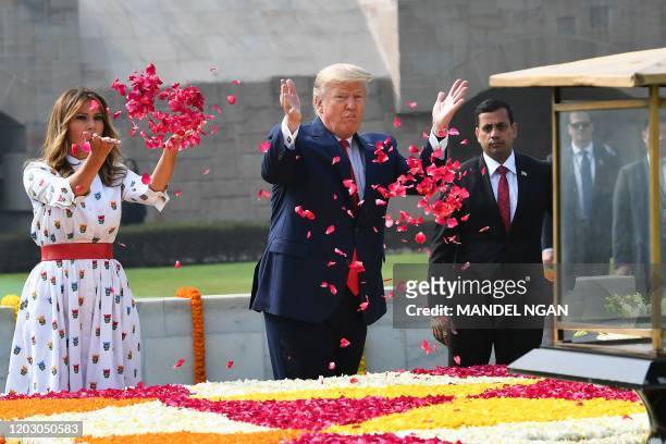 President Donald Trump and First Lady Melania Trump spray rose petals to pay tribute at Raj Ghat, the memorial for Indian independence icon Mahatma...
