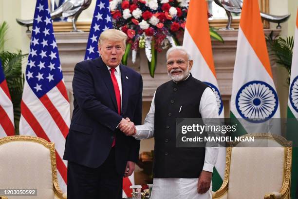 India's Prime Minister Narendra Modi shakes hands with US President Donald Trump before a meeting at Hyderabad House in New Delhi on February 25,...