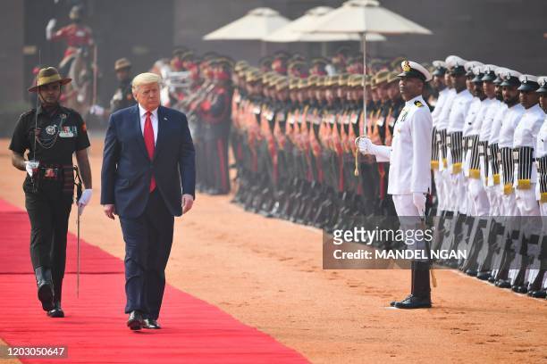 President Donald Trump reviews a guard of honour during a ceremonial reception at Rashtrapati Bhavan - The Presidential Palace in New Delhi on...