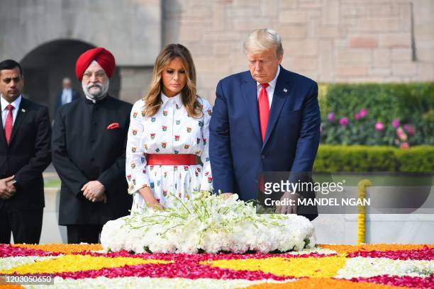 President Donald Trump and First Lady Melania Trump lay a wreath to pay their tribute at Raj Ghat, the memorial for Indian independence icon Mahatma...