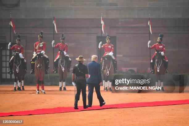 President Donald Trump reviews a guard of honour during a ceremonial reception at Rashtrapati Bhavan - The Presidential Palace in New Delhi on...