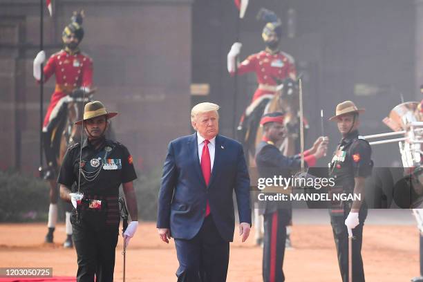 President Donald Trump reviews a guard of honour during a ceremonial reception at Rashtrapati Bhavan - The Presidential Palace in New Delhi on...