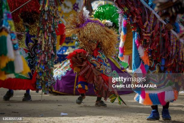 Reveller takes part in the Maracatu de Baque Solto street carnival parade in Olinda, Pernambuco State, in northeast of Brazil, on February 24, 2020....