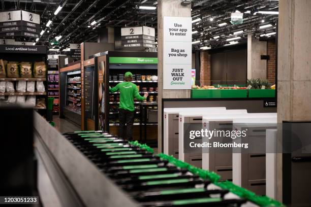 An employee stocks refrigerated food during a tour of a new Amazon Go store in the Capitol Hill neighborhood of Seattle, Washington, U.S., on Monday,...