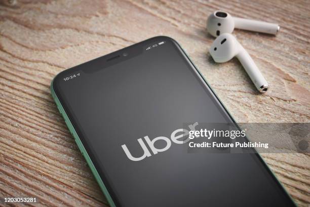 An Apple iPhone 11 smartphone with the Uber taxi app logo on screen, taken on January 27, 2020.