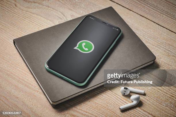 An Apple iPhone 11 smartphone with the WhatsApp instant messaging app logo on screen, taken on January 27, 2020.
