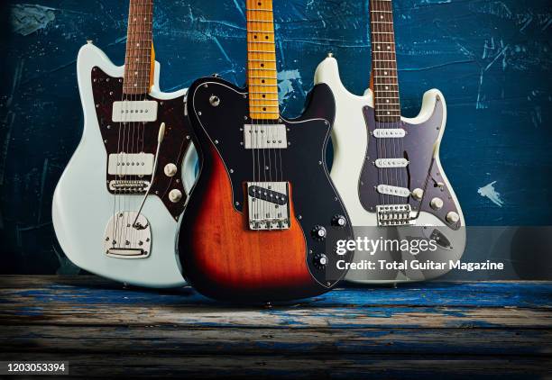 Trio of Squier Classic Vibe series electric guitars, including a 60s Jazzmaster, 70s Telecaster Custom and a 70s Stratocaster, taken on July 22, 2019.