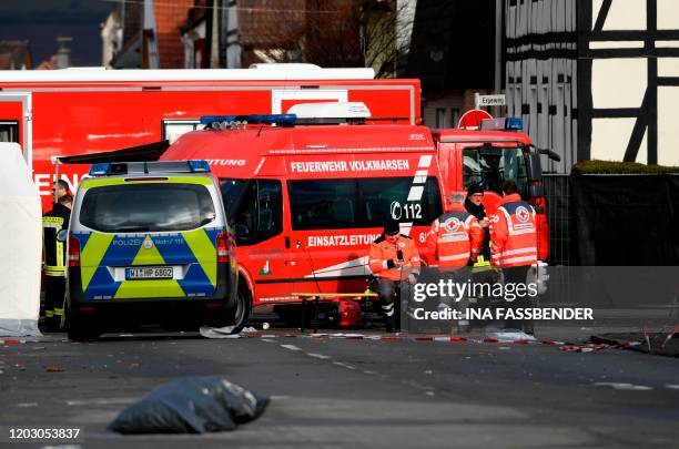 Vehicles of the police and the fire brigades stand at the site where a man who drove into a carnival procession, on February 25, 2020 in Volkmarsen...